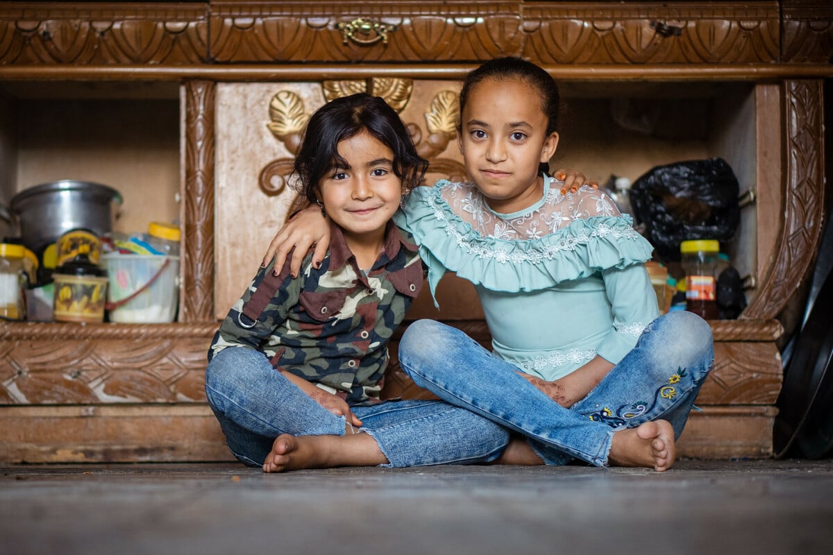 Two children sitting on the floor